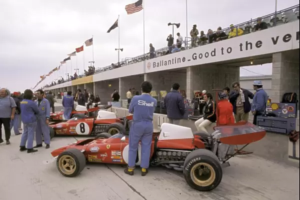 Formula One World Championship: Fifth placed Jacky Ickx sits on the pit wall beside his Ferrari 312B2 during practice