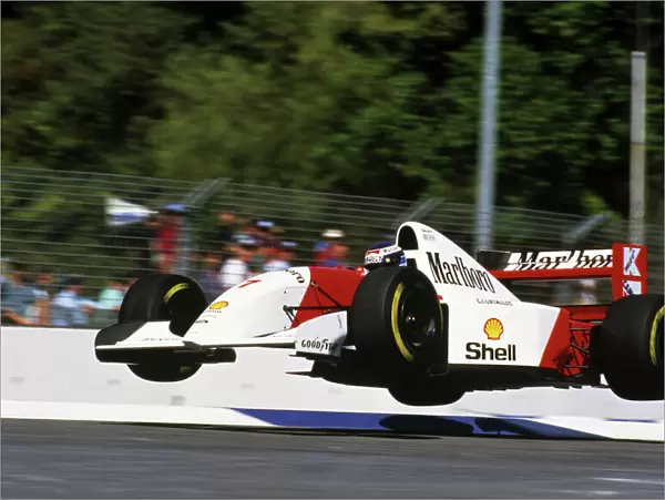 Formula One World Championship: The Flying Finn Mika Hakkinen launches his Mclaren MP4  /  8 into the air at the Malthouse Corner during a lap in