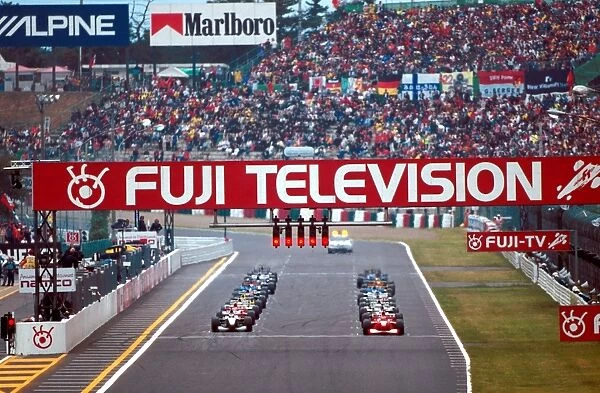 2000 Japanese Grand Prix: Michael Schumacher on pole with Mika Hakkinen next to him on the front row of the grid at the start