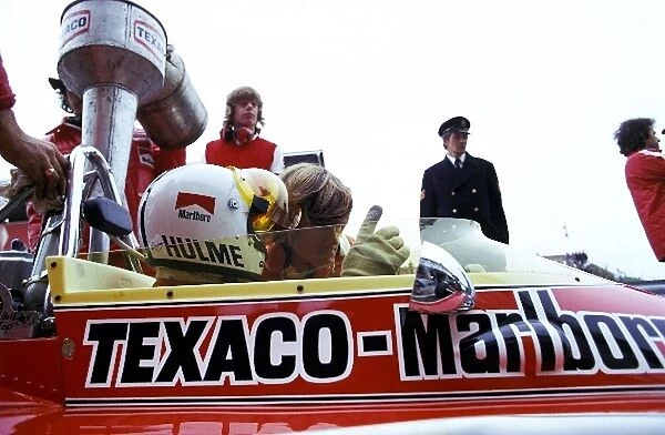 Formula One World Championship: Denny Hulme, who retired on lap 66 with a broken ignition, has his McLaren M23 topped up with Texaco fuel during
