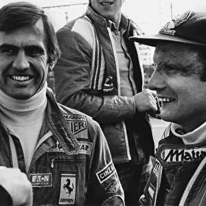 1977 Spanish Grand Prix: Jarama, Madrid, Spain. 6th - 8th May 1977. Carlos Reutemann and team mate Niki Lauda share a joke in the paddock, portrait