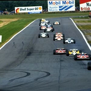 Alain Prost leads the field around on the first lap of the Silverstone race