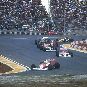 Interlagos, Sao Paulo, Brazil: Poleman Ayrton Senna easily leads teammate Gerhard Berger, Thierry Boutsen, Alain Prost, Nigel Mansell, Riccardo Patrese