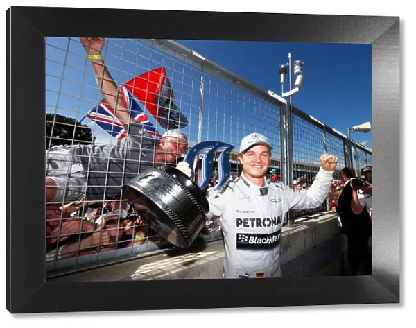 2013 British Grand Prix - Sunday: Nico Rosberg, Mercedes AMG, 1st position, shows his trophy to the crowd