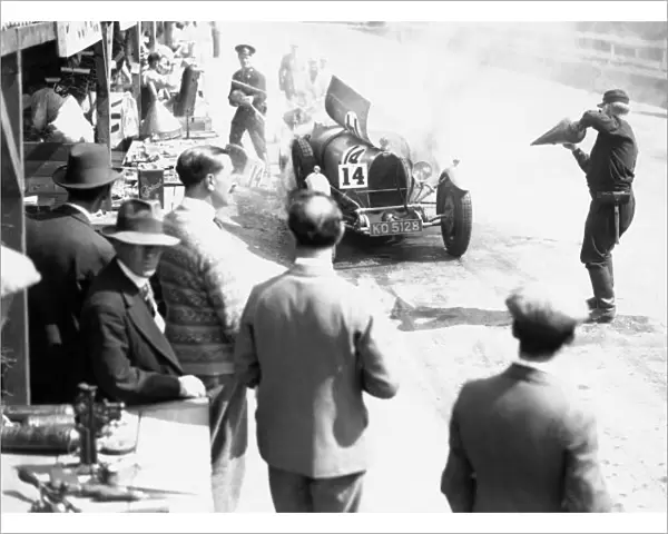1929 Irish Grand Prix. Car number 14, catches fire in the pit lane, action