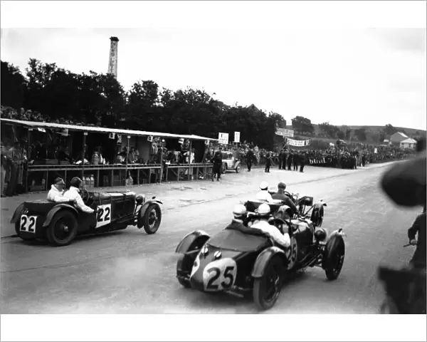 1931 Tourist Trophy. Ards, Northern Ireland, Great Britain: HJ Aldington and Augustus Cesare Bertelli  /  Jack Bezzant pass the pits