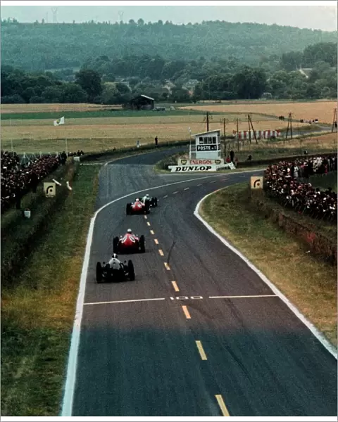 Formula One World Championship: Eventual race winner Jack Brabham Cooper Climax T53 leads Phil Hill Ferrari D246 and Wolfgang von Trips Ferrari D246