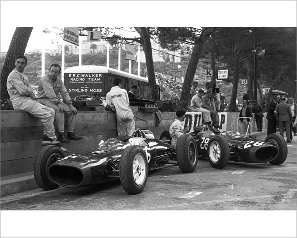 Formula One World Championship: Roy Salvadori with his team mate John Surtees wait patiently for action alongside their Lola Mk4├òs during practice