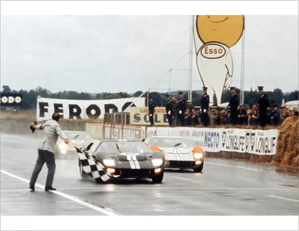 Le Mans 24 Hour Race: Bruce McLaren and Chris Amon Ford GT40 Mk II take the chequered flag to win just ahead of Shelby American Inc. team mates Denny Hulme