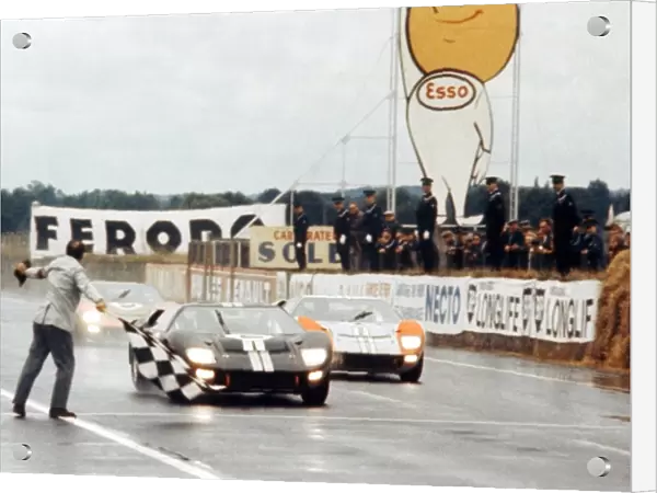 Le Mans 24 Hour Race: Bruce McLaren and Chris Amon Ford GT40 Mk II take the chequered flag to win just ahead of Shelby American Inc. team mates Denny Hulme