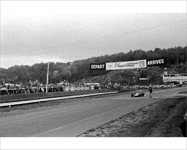 Formula One World Championship: Race winner Denny Hulme McLaren M7A takes the chequered flag