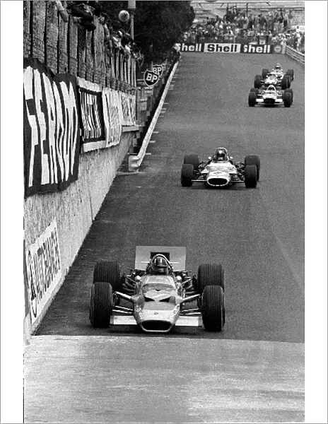 Formula One World Championship: Graham Hill Lotus 49B, winner of Monaco for a historic fifth time in seven years, leading Jean-Pierre Beltoise