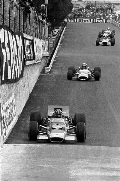 Formula One World Championship: Graham Hill Lotus 49B, winner of Monaco for a historic fifth time in seven years, leading Jean-Pierre Beltoise