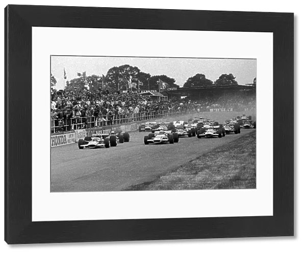 Formula One World Championship: Start, Pole position man Jochen Rindt Lotus 49B, left, has the jump on Jackie Stewart Matra MS80, right