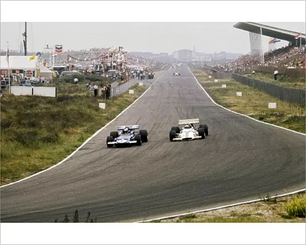 Formula One World Championship: Second placed Jackie Stewart Tyrrell Racing Organisation March 701 passes race retiree Jackie Oliver BRM P153