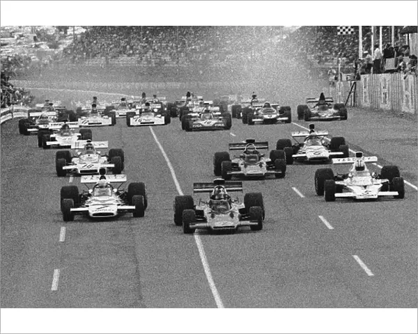 Formula One World Championship: The start with the Lotus of Emerson Fittipaldi getting the jump on the Mclarens of Jody Scheckter left, and Denny Hulme