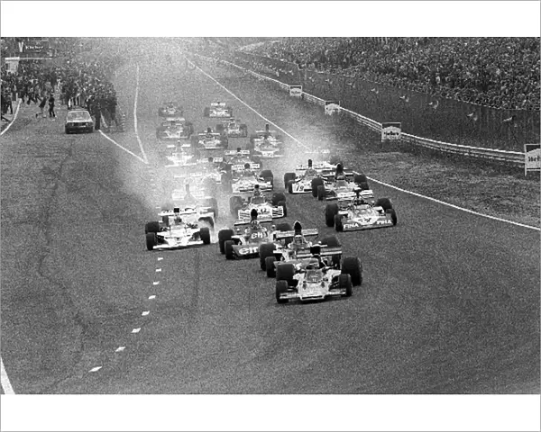 Formula One World Championship: Pole sitter Ronnie Peterson Lotus 72E leads the field into Tarzan at the start of the race