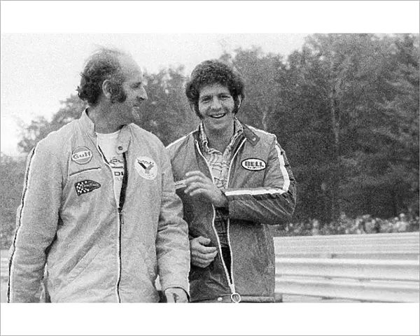 Formula One World Championship: Fourth placed Denny Hulme McLaren enjoys a joke with team mate Jody Scheckter, who retired from the race