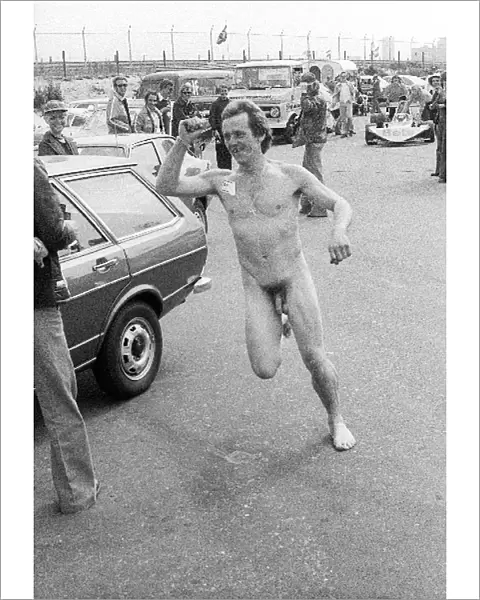 Formula One World Championship: A mechanic runs through the paddock naked except for a Brabham sticker on his chest