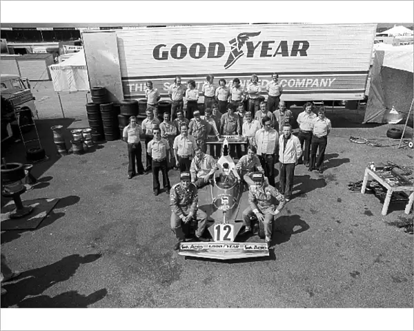 Formula One World Championship: The Ferrari team gather for a group photograph with drivers Niki Lauda and Clay Regazzoni sitting on the front