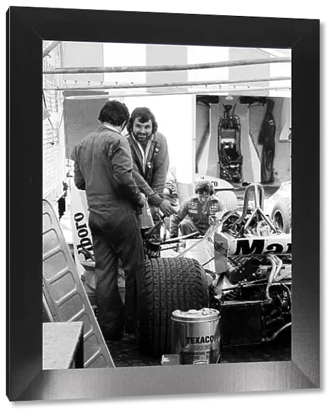 Formula One World Championship: Mechanics work on the McLaren M23 of James Hunt in the paddock