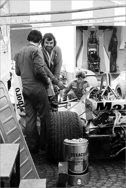 Formula One World Championship: Mechanics work on the McLaren M23 of James Hunt in the paddock