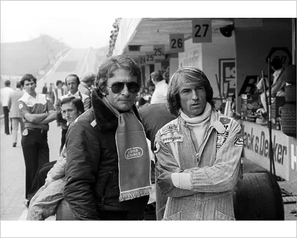 Formula One World Championship: Gerard Ducarouge Ligier Team Manager in the pit lane with second placed Jacques Laffite Ligier