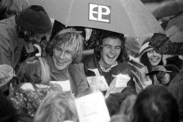 Formula One World Championship: New F1 World Champion James Hunt McLaren and 500cc Motorbike World Champion Barry Sheene are mobbed by fans