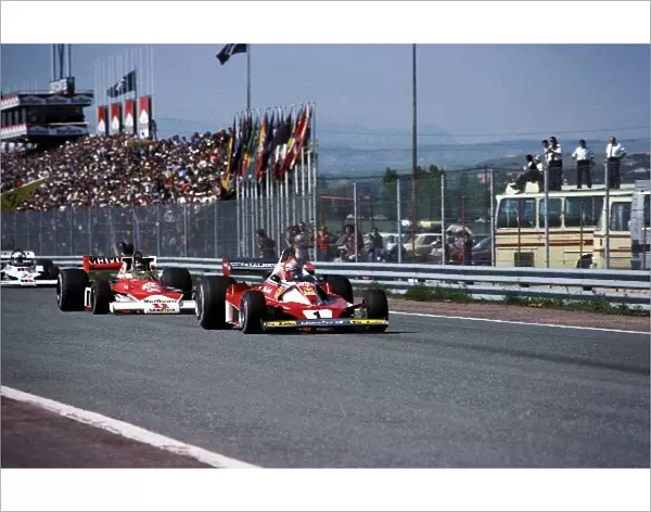 Formula One World Championship: Second placed Niki Lauda Ferrari 312T2 leads James Hunt McLaren M23, who won, was then disqualified for a technical