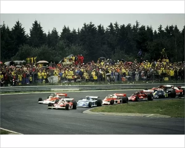 Formula One World Championship: Ninth placed Clay Regazzoni Ferrari 312T2 leads at the start of the race from race winner James Hunt McLaren