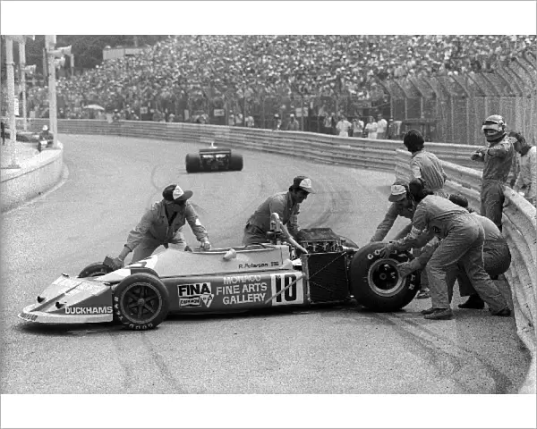 Formula One World Championship: Marshals clear the March 761 of Ronnie Peterson, who crashed out at Tabac after hitting the deposited oil of