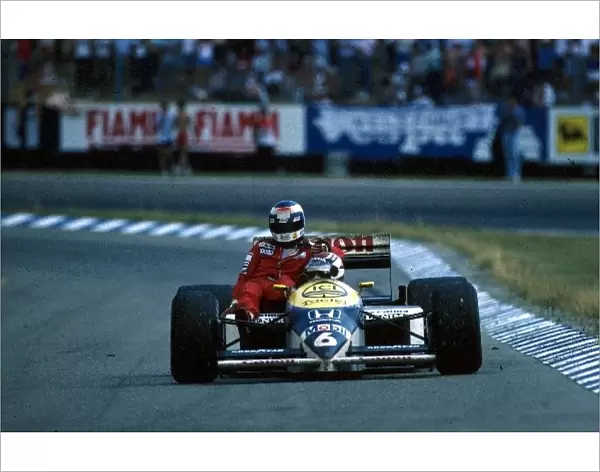 Formula One World Championship: Winner Nelson Piquet Williams FW11, gives Keke Rosberg McLaren a lift back to the pits