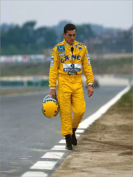 Formula One World Championship: Ayrton Senna Lotus 99T walks back to the after a practice spin