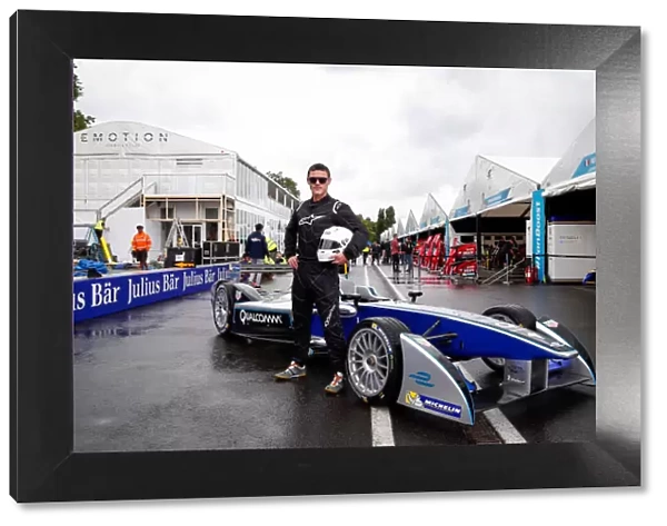 L5R0534. Luke Evans Poses with the Formula E Car.