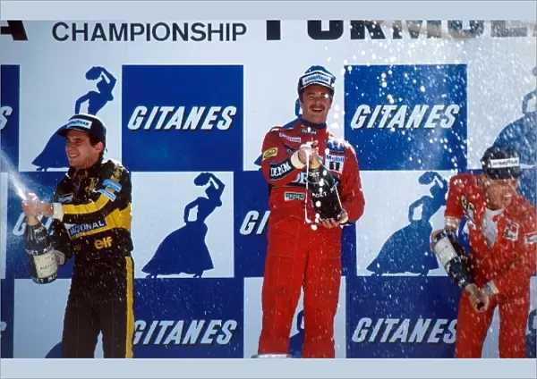 Formula One World Championship: The podium: Ayrton Senna Lotus second; Nigel Mansell Williams winner; Stefan Johansson Ferrari third