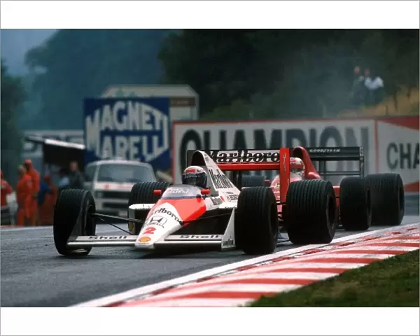 Formula One World Championship: Second place finisher Alain Prost McLaren MP4  /  5 leads third place finisher Nigel Mansell Ferrari 640