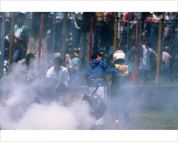 Formula One World Championship: Philippe Alliot walks away from the wreckage of his Larrousse Lola LC88 Ford
