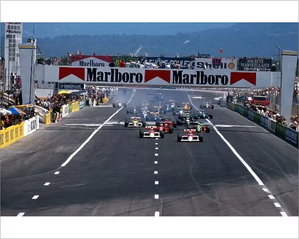 Formula One World Championship: Winner Alain Prost McLaren MP4  /  5 leads the field away at the start