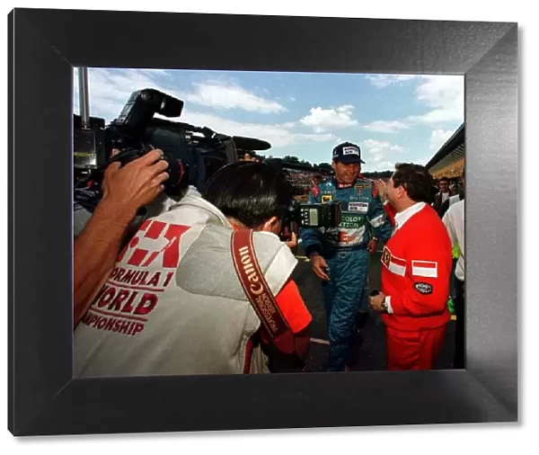 1997 GERMAN GP. Gerhard Berger is congratulated by Ferraris Jean Todt after securing