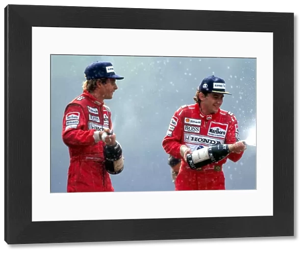 Formula One World Championship: R-L: Race winner Ayrton Senna McLaren, sprays champagne with third placed Gerhard Berger McLaren, on the podium