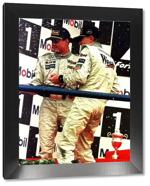 1997 EUROPEAN GP. Mika Hakkinen and David Coulthard celebrate a McLaren 1-2 in Jerez