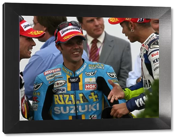 Friends Valentino Rossi and Loris Capirossi discuss their race with runner up Toni Elias