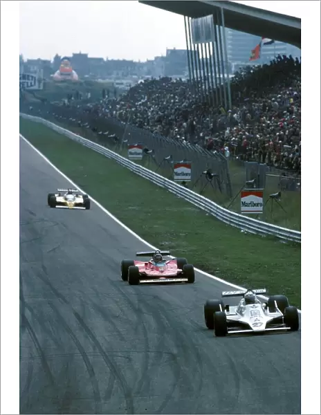 Formula One World Championship: Alan Jones Williams FW07 leads Gilles Villeneuve Ferrari 312T4 and Jean Pierre Jabouille Renault RS10