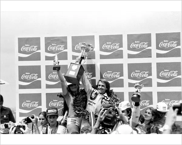 Formula One World Championship: Race winner Jacques Laffite Ligier celebrates on the podium