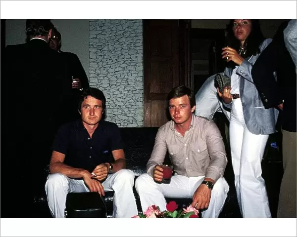 Formula One World Championship: Race retiree Patrick Depailler Tyrrell enjoys a cigarette at a party as team mate Didier Pironi, who scored