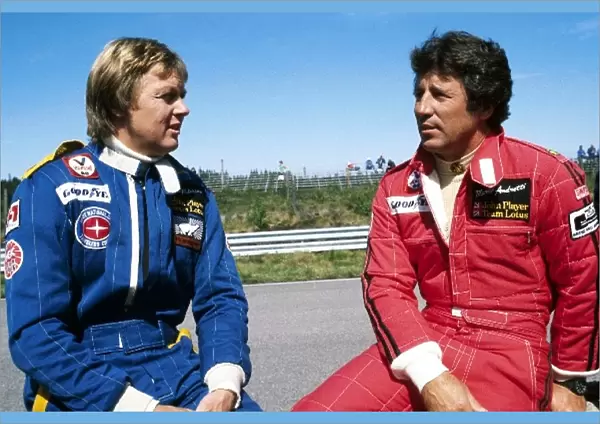 Formula One World Championship: Third placed Ronnie Peterson talks with his Lotus team mate Mario Andretti, who was battling for the lead of