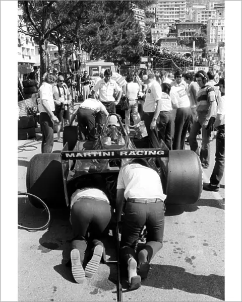 Formula One World Championship: Lotus mechanics work on the Lotus 79 of third placed Carlos Reutemann in the pits