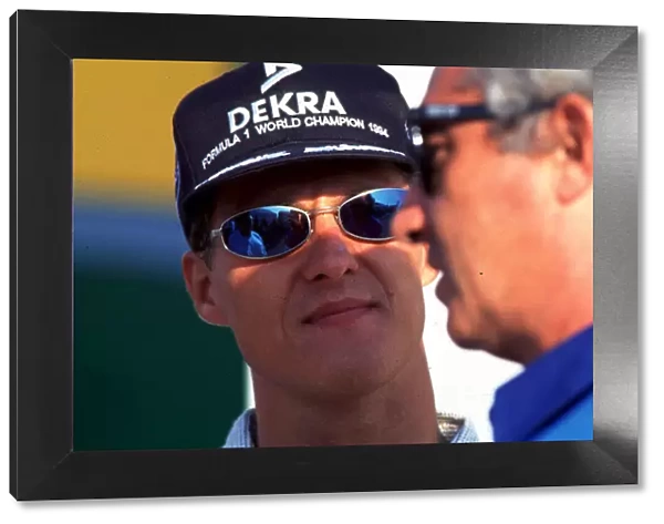 1995 PORTUGESE GP. Michael Schumacher and Flavio Briatore. Photo: LAT