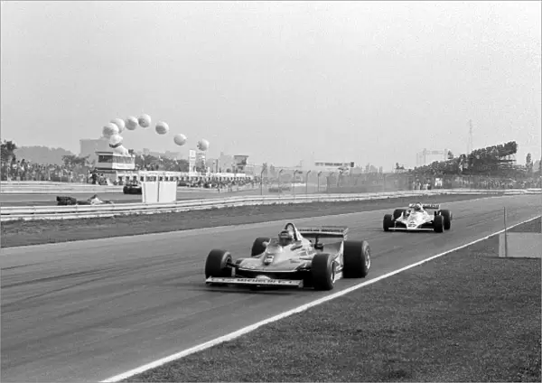 Formula One World Championship: Second placed Gilles Villeneuve Ferrari 312T4 leads the race from eventual race winner Alan Jones Williams FW07