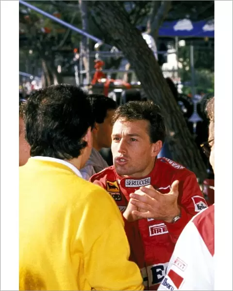 Formula One World Championship: Andrea de Cesaris Dallara, who finished the race in thirteenth position, has an animated conversation in the pit area
